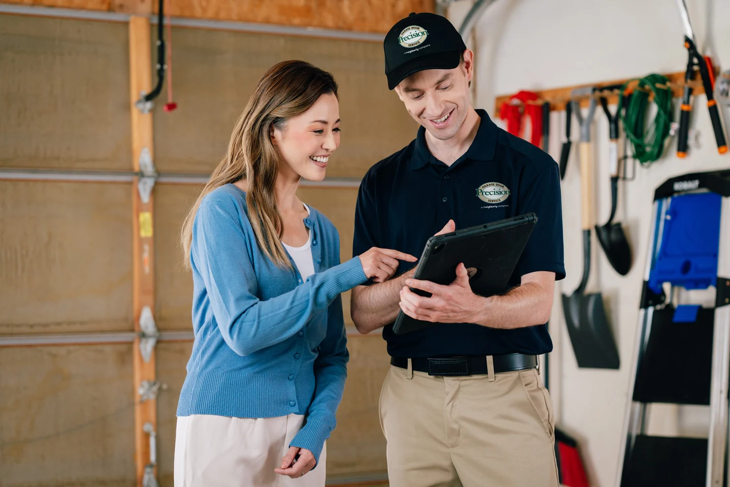 Precision technician and customer reviewing repairs Precision technician and customer reviewing repairs