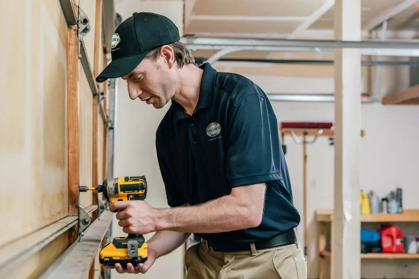 Garage door repairman fixing the inside of a garage door